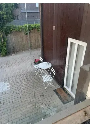 a patio with a table and chairs next to a building at Private, Cozy Home in Kaunas