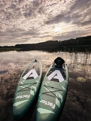 two kayaks sitting in the water on a lake at Bonanza Terra in Rukliai