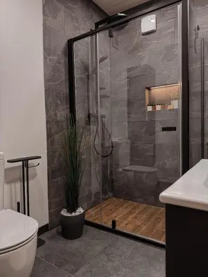 a shower with a glass door in a bathroom at Bonanza Terra in Rukliai