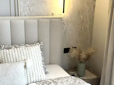 a bedroom with a bed and a vase of flowers at Žaliakalnis Luxury Suites in Kaunas