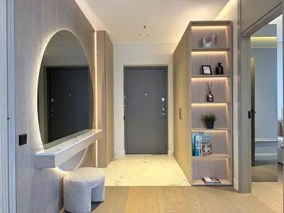 a hallway with a door and a stool and a mirror at Žaliakalnis Luxury Suites in Kaunas
