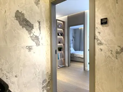 a hallway with a wall covered in mold at Žaliakalnis Luxury Suites in Kaunas