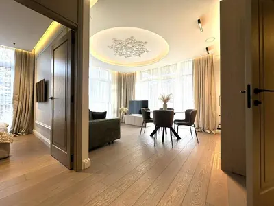 a living room with a table and a dining room at Žaliakalnis Luxury Suites in Kaunas