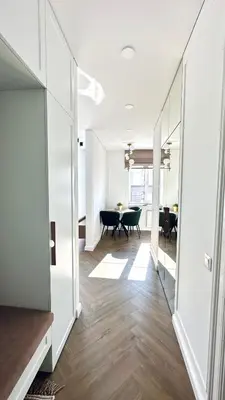 an open hallway with a dining room and a table at Šviesus ir šiltas butas Šiaulių miesto centre in Šiauliai