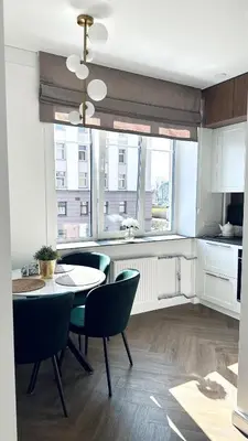 a kitchen with a table and chairs in a room at Šviesus ir šiltas butas Šiaulių miesto centre in Šiauliai