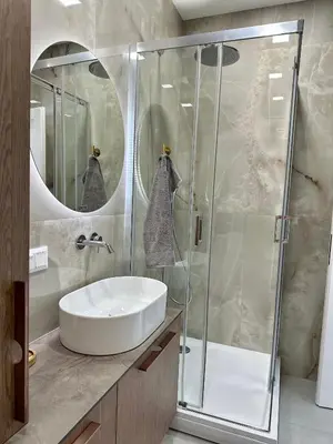 a bathroom with a sink and a shower at Šviesus ir šiltas butas Šiaulių miesto centre in Šiauliai