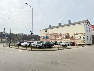 a parking lot with cars parked in front of a building at Old Town Hideaway in Kaunas