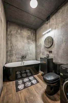 a bathroom with a bath tub and a toilet at City Center Panoramic Penthouse With Rooftop Terrace - Self Check-in in Vilnius