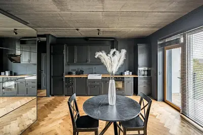 a kitchen with a table with a vase on it at City Center Panoramic Penthouse With Rooftop Terrace - Self Check-in in Vilnius