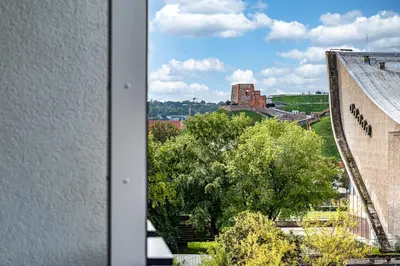 a view from a window of a building and a tree at City Center Panoramic Penthouse With Rooftop Terrace - Self Check-in in Vilnius