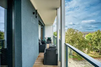 a balcony with a view of a house at City Center Panoramic Penthouse With Rooftop Terrace - Self Check-in in Vilnius