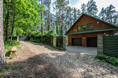 a house with a driveway leading to a garage at Villa Emerald in Luokesos Sen