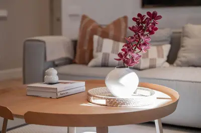 a vase with flowers on a table in a living room at 2 Bedroom I 85 m2 I w-Balcony I Malunu st Apt I cohost in Vilnius