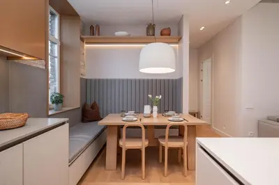 a dining room with a table and chairs in a kitchen at 2 Bedroom I 85 m2 I w-Balcony I Malunu st Apt I cohost in Vilnius
