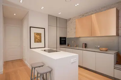 a kitchen with a white counter and stools at 2 Bedroom I 85 m2 I w-Balcony I Malunu st Apt I cohost in Vilnius
