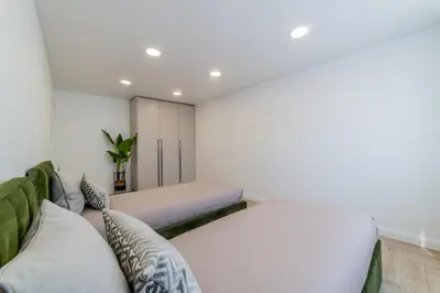 a bedroom with two beds and a couch at Frida Luxury Apartments in Šiauliai