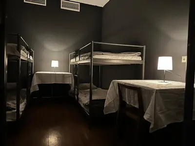 two bunk beds in a room with two lamps at The Kliefs Vilnius - Virtual Check-In in Vilnius