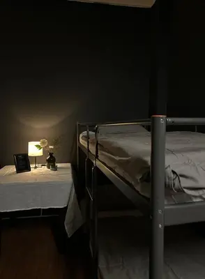 a bedroom with two bunk beds and a table with a lamp at The Kliefs Vilnius - Virtual Check-In in Vilnius