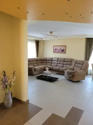 a living room with a couch and a table at Vaido apartamentai in Marijampolė