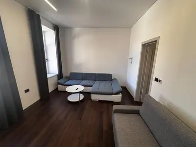 a living room with a couch and a table at Modern Flat in Centre, Self Check-In, Free parking in Vilnius