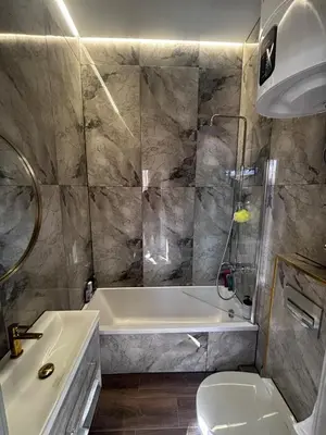 a bathroom with a tub and a toilet and a sink at Modern Flat in Centre, Self Check-In, Free parking in Vilnius