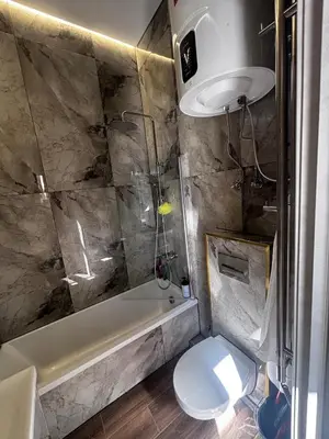 a bathroom with a toilet and a tub and a sink at Modern Flat in Centre, Self Check-In, Free parking in Vilnius