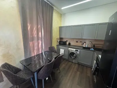 a kitchen with a table and chairs in a kitchen at Modern Flat in Centre, Self Check-In, Free parking in Vilnius