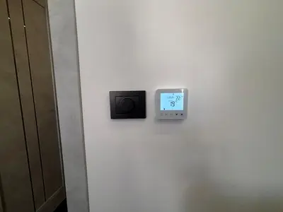 a clock on a wall with a tv on a wall at Modern Flat in Centre, Self Check-In, Free parking in Vilnius