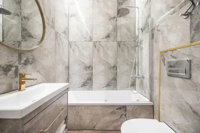 a bathroom with a shower and a sink and a toilet at Modern flat , Self check in 24h, Netflix, parking in Vilnius