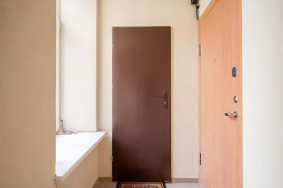 a bathroom with a brown door and a sink at Modern flat , Self check in 24h, Netflix, parking in Vilnius