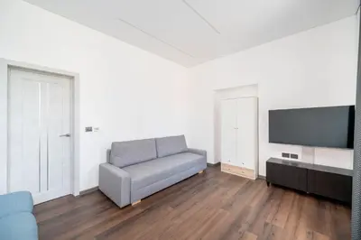 a living room with a couch and a flat screen tv at Modern flat , Self check in 24h, Netflix, parking in Vilnius