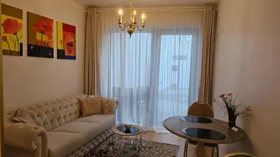 a living room with a couch and a table at Butas su terasa Kauno centre pirmame aukšte Clinic in Kaunas