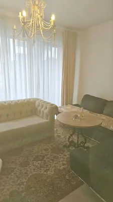a living room with a couch and a table at Butas su terasa Kauno centre pirmame aukšte Clinic in Kaunas