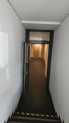 a hallway with an open door leading to a room at Butas su terasa Kauno centre pirmame aukšte Clinic in Kaunas