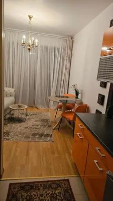 a living room with a table and a dining room at Butas su terasa Kauno centre pirmame aukšte Clinic in Kaunas