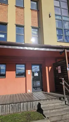 a building with a door and stairs in front of it at Butas su terasa Kauno centre pirmame aukšte Clinic in Kaunas