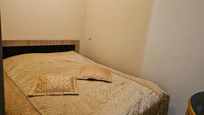 a small bedroom with a bed with a pillow on it at Butas su terasa Kauno centre pirmame aukšte Clinic in Kaunas