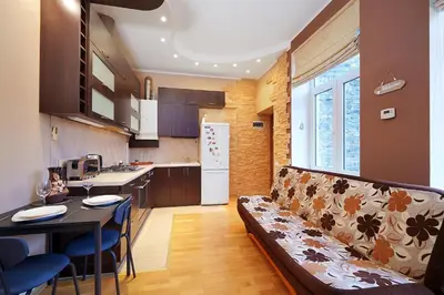 a living room with a couch and a kitchen at Jablonskis Apartment in Vilnius