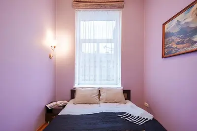 a bedroom with a bed in front of a window at Jablonskis Apartment in Vilnius