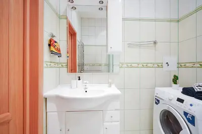 a bathroom with a sink and a washing machine at Jablonskis Apartment in Vilnius