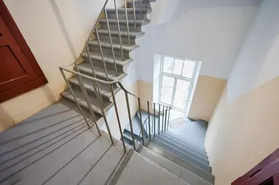 a spiral staircase in a house with a window at Jablonskis Apartment in Vilnius