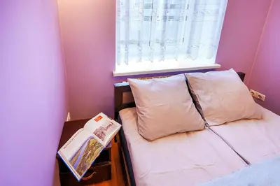 a small bedroom with a bed and a window at Jablonskis Apartment in Vilnius