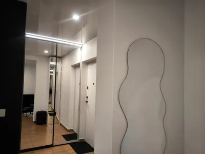 a hallway with a large white sculpture on the wall at DOMINO apartamentai, SELF CHECK-IN in Panevėžys