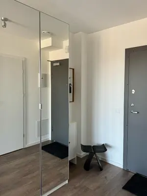 a glass partition in a room with a chair at Ozas Cozy Studio apartment in Vilnius
