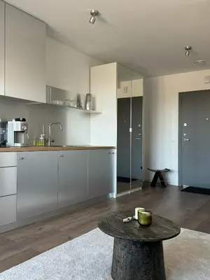 a kitchen with a table in the middle of a room at Ozas Cozy Studio apartment in Vilnius