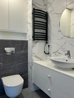 a bathroom with a white sink and a toilet at Ozas Cozy Studio apartment in Vilnius