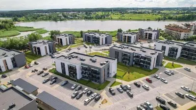 an aerial view of a large parking lot with buildings at Apartamentai prie ežero in Vilnius
