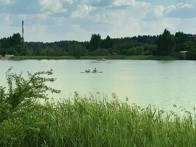 a group of people in a boat on a lake at Apartamentai prie ežero in Vilnius