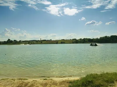 a large body of water with a boat in it at Apartamentai prie ežero in Vilnius