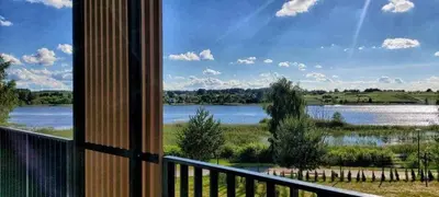 a view of a lake from a balcony at Apartamentai prie ežero in Vilnius